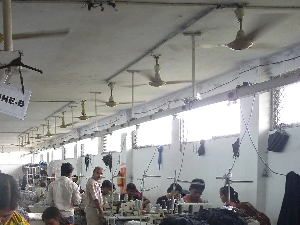 Rows of sewing machines on a garment factory floor