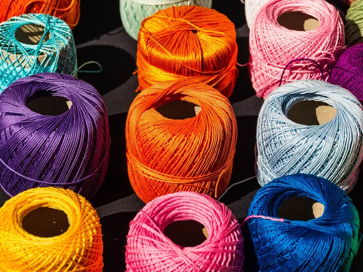 Brightly dyed balls of cotton thread