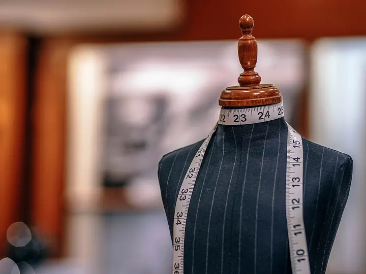 A tailor’s dummy with a measuring tape